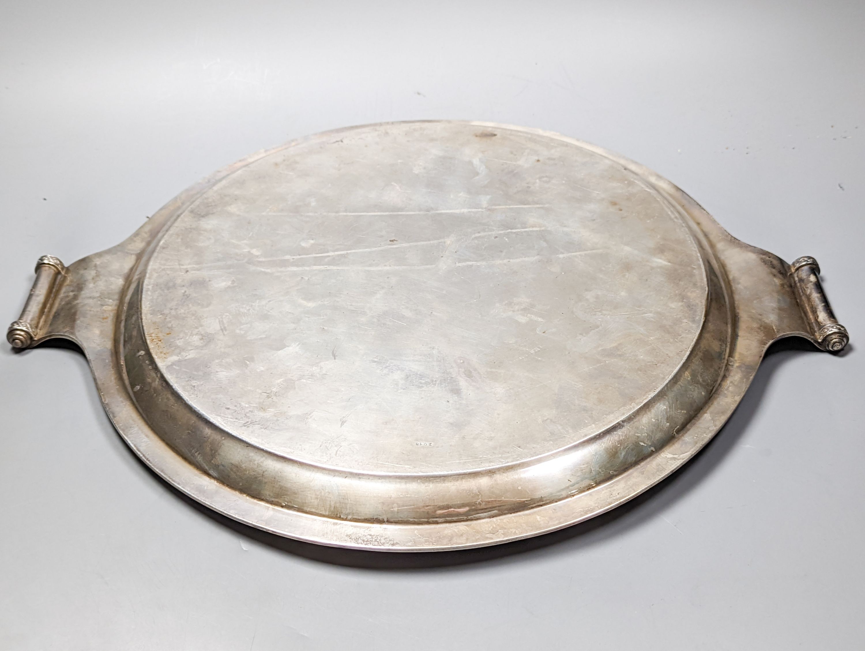 A George V silver circular two handled tray, with engraved border, John Round & Son Ltd, Sheffield, 1929, diameter 45.2cm over handles